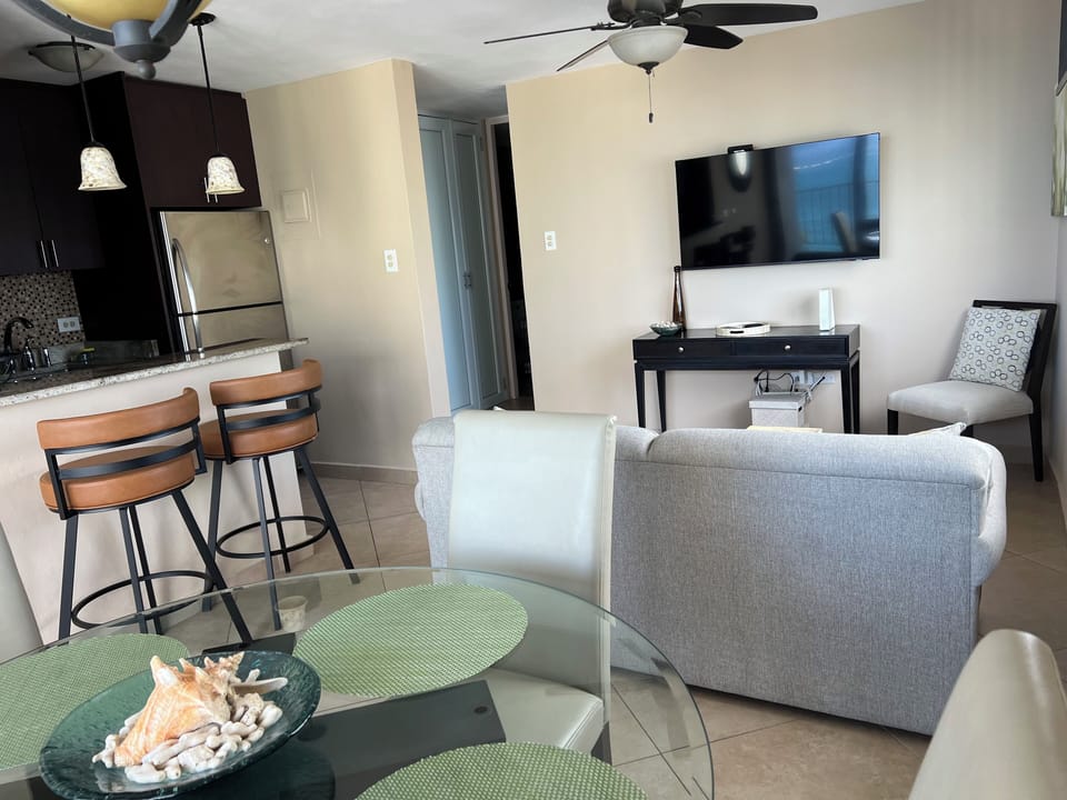 Living area including island and barstools