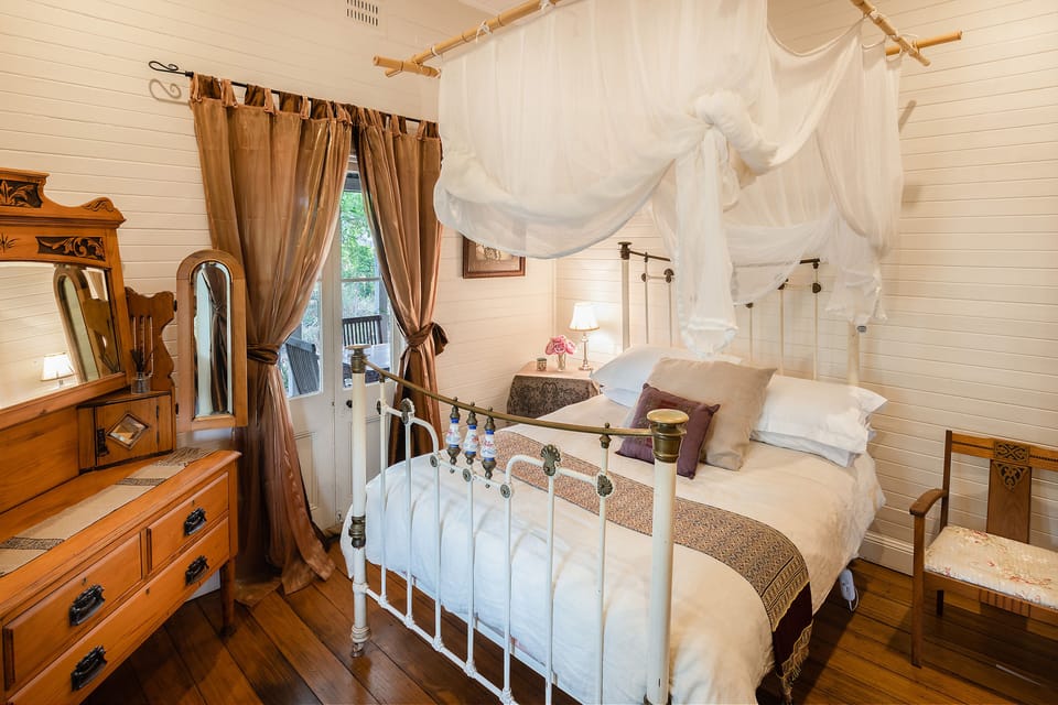 Bedroom One. Antique charm and comfort. Doors open out to verandah