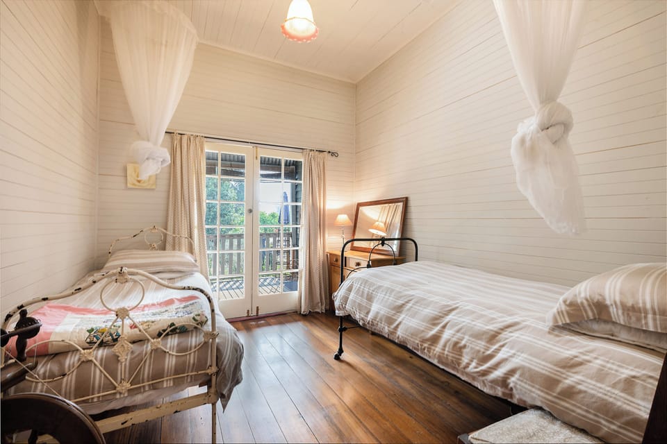 Bedroom three has two comfy single beds and opens out to the verandah and garden