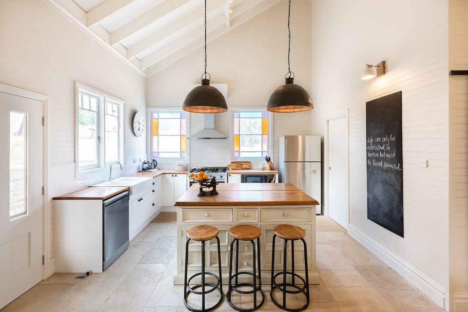 The modern new kitchen with stunning lead light windows and breakfast bar