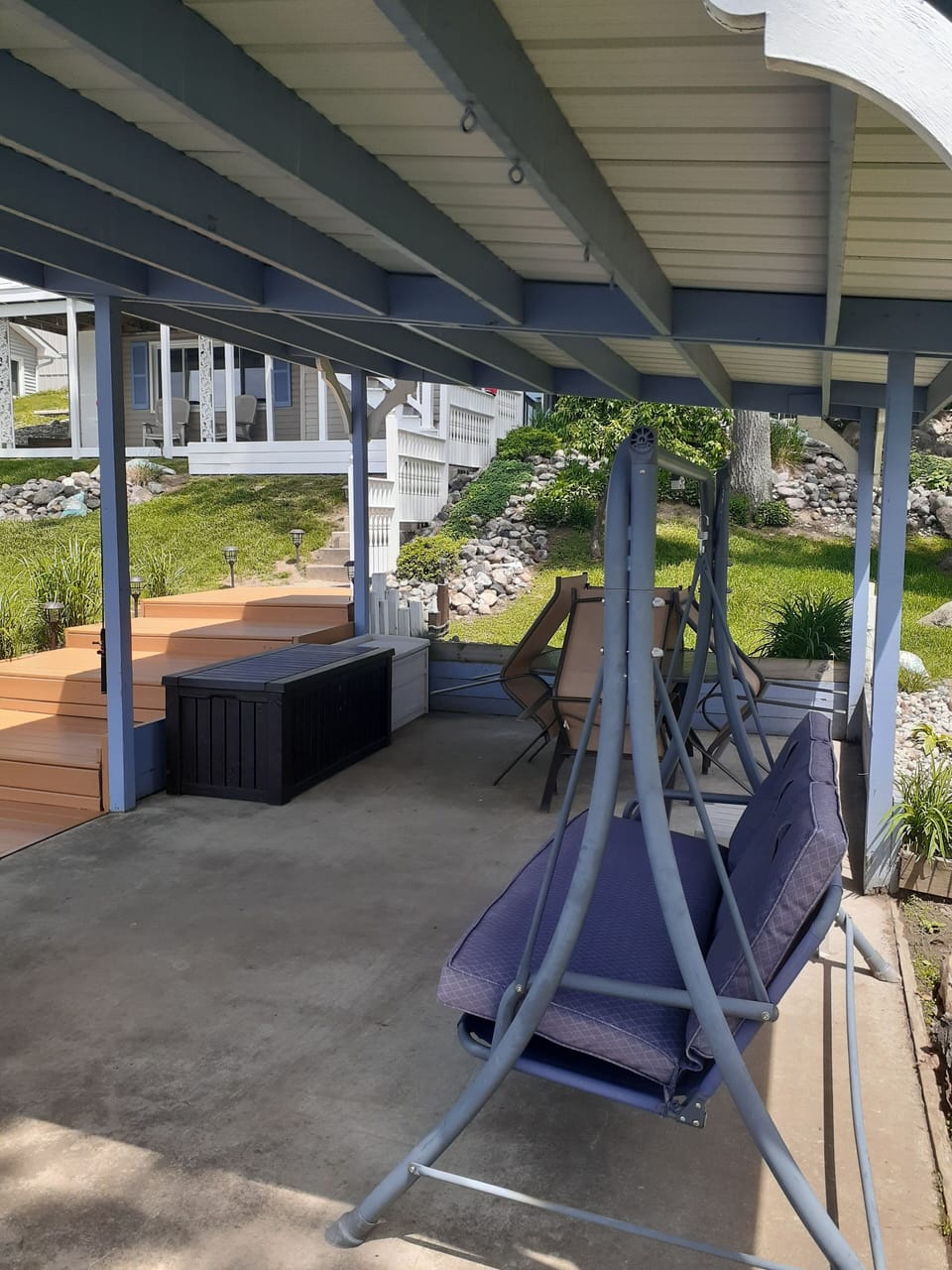 Covered Pavilion with Swing, Table & 4 Chairs, deck boxes with toys and games 
