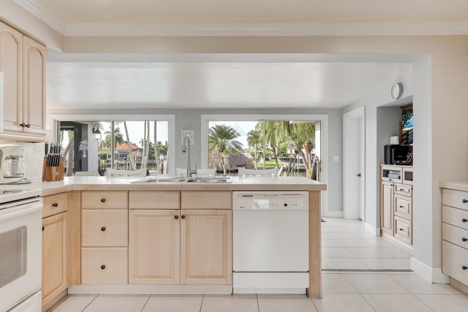 Large kitchen with views of the backyard and canal.