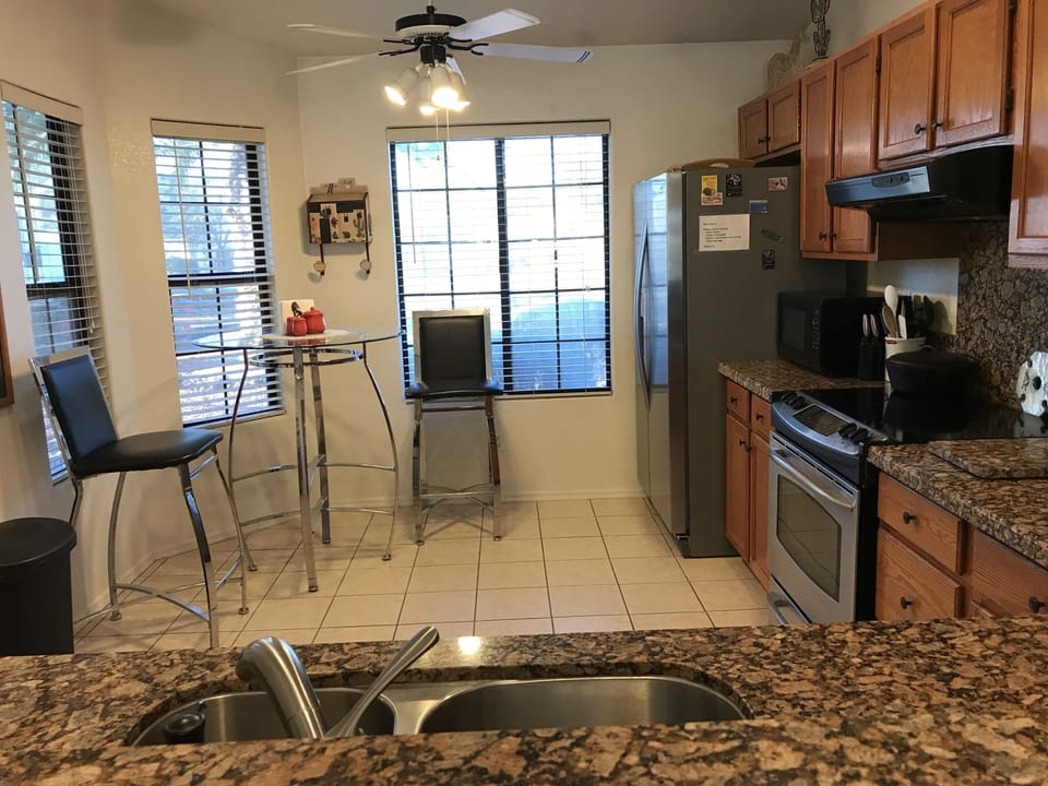 Stainless double sink in the eat-in kitchen looking out to street view