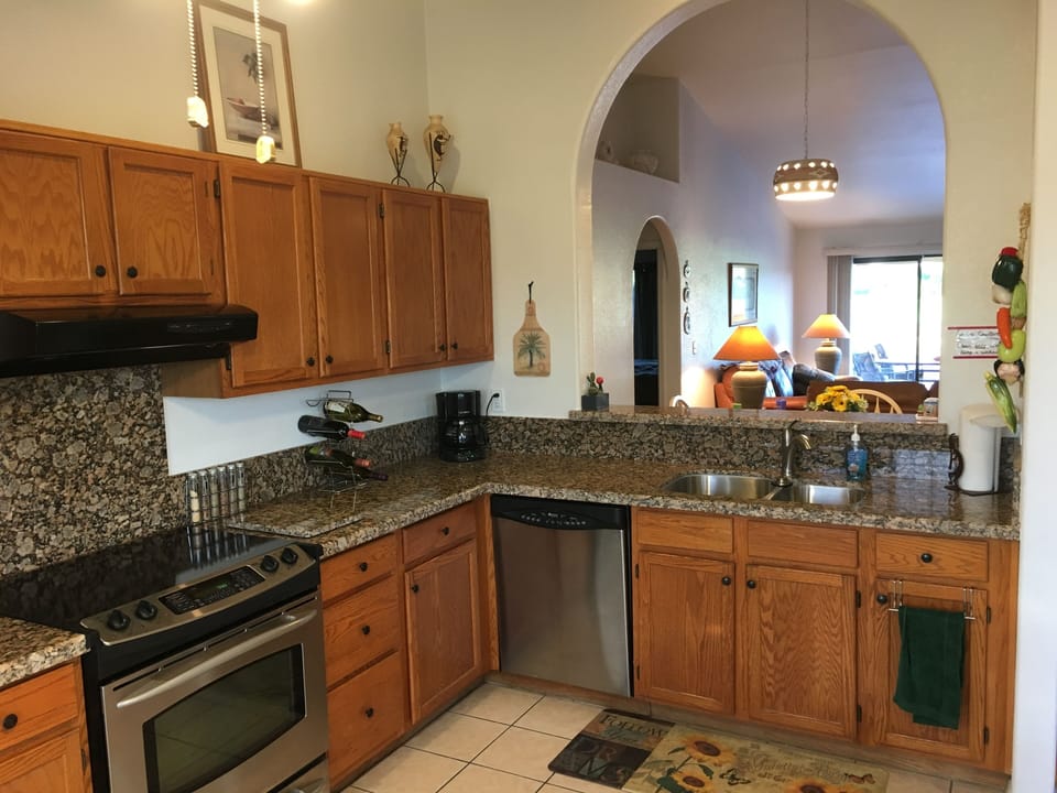 Granite countertops in a fully equipped kitchen w/many appliances, bakeware, etc