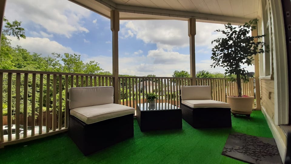 Second story porch with turf flooring and new patio furniture.