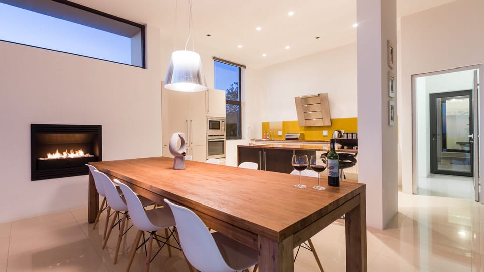 dining area with fireplace and modern European kitchen with fireplace