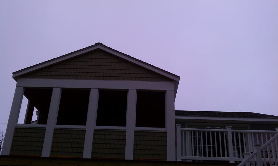Screen Porch and deck off living area. Wonderful living space and great sunsets!
