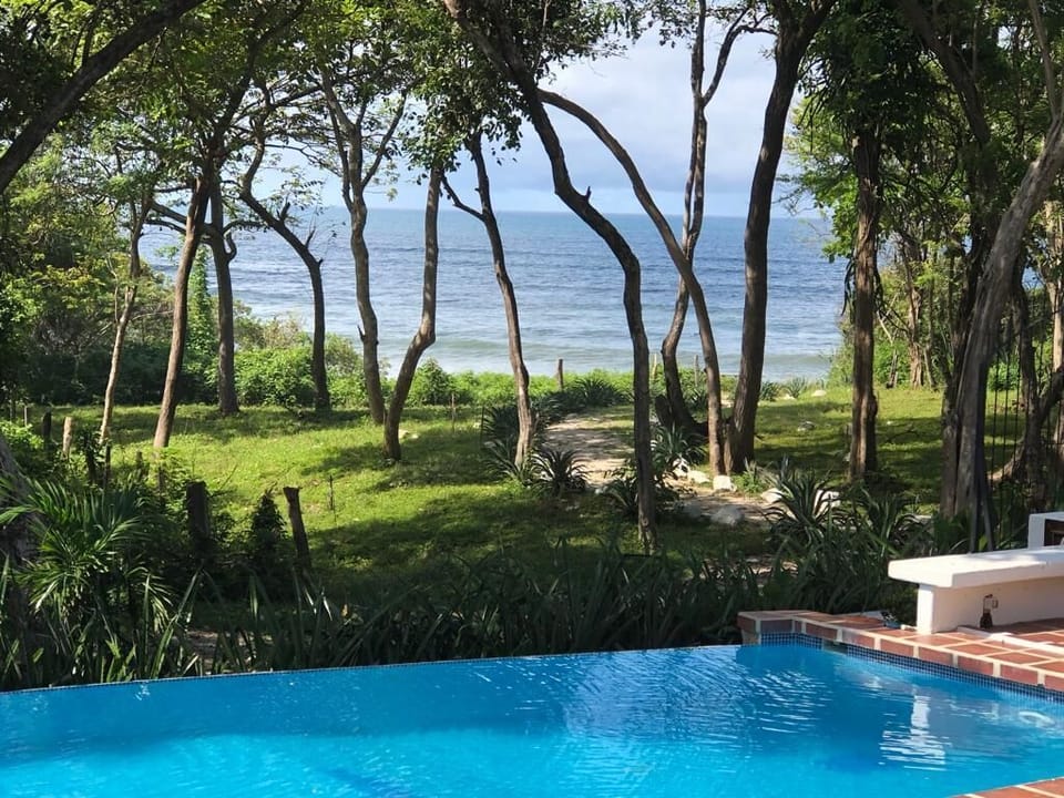 A short path leads from the pool to the beach