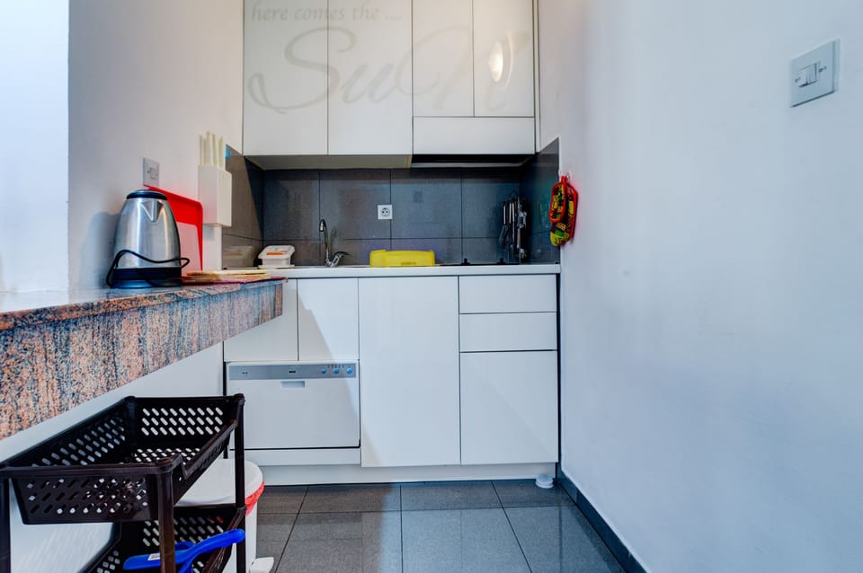 The Kitchen with all necessary kitchen elements.