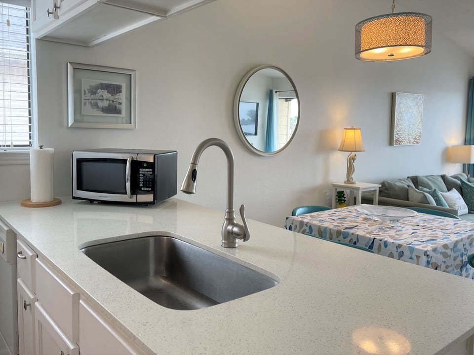 Deep sink with lots of countertop and cabinet space.