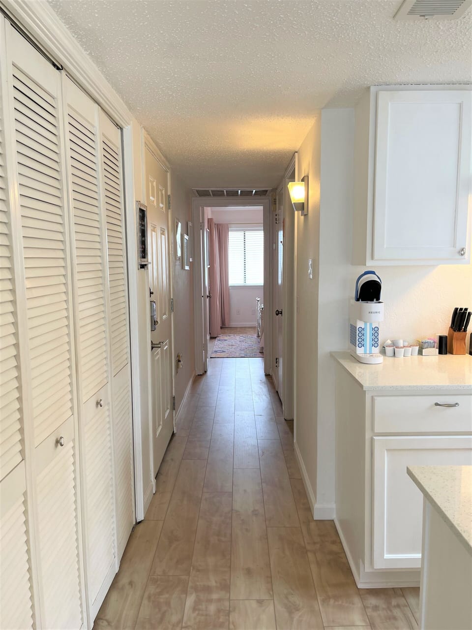 Looking down the hall towards the bedroom at the end.