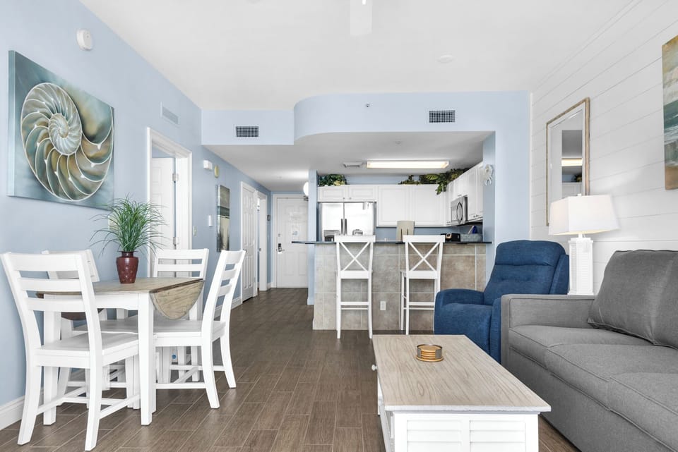 Dining Area - Gather loved ones around this cozy dining space for two, where each meal is elevated by serene beach views and natural light. Included are 2 bar seats for extra seating.