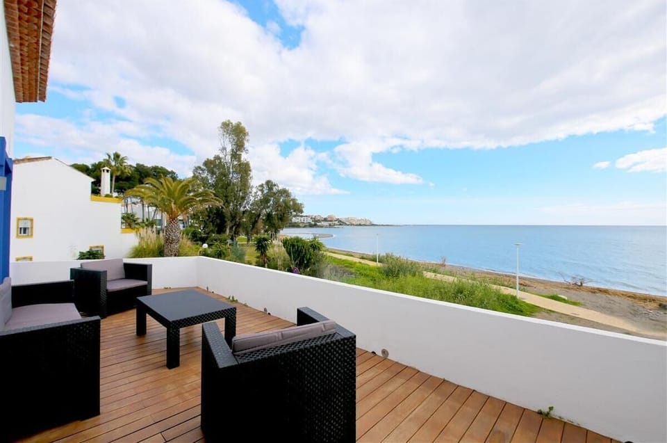 Upper terrace with comfortable seating area and stunning sea views
