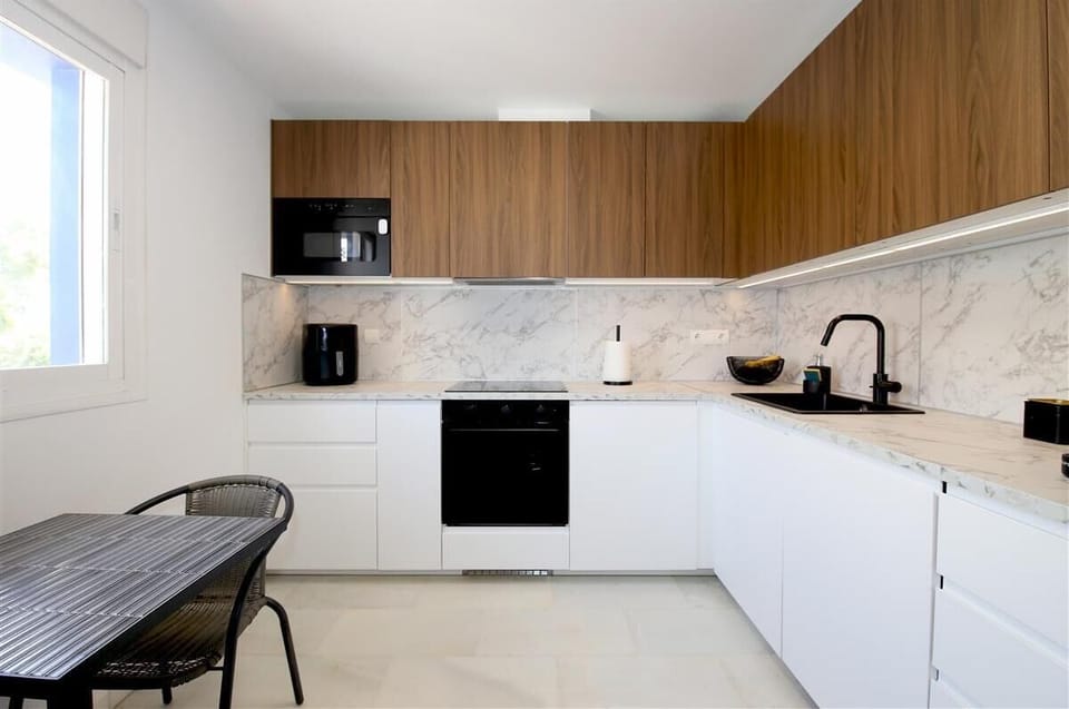 Modern fully fitted kitchen with dining area for two guests