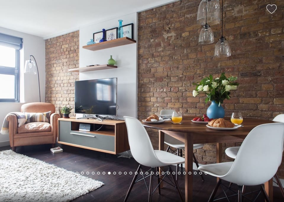 Large Smart TV with Freeview and Netflix. Walnut dining table & Eames chairs.