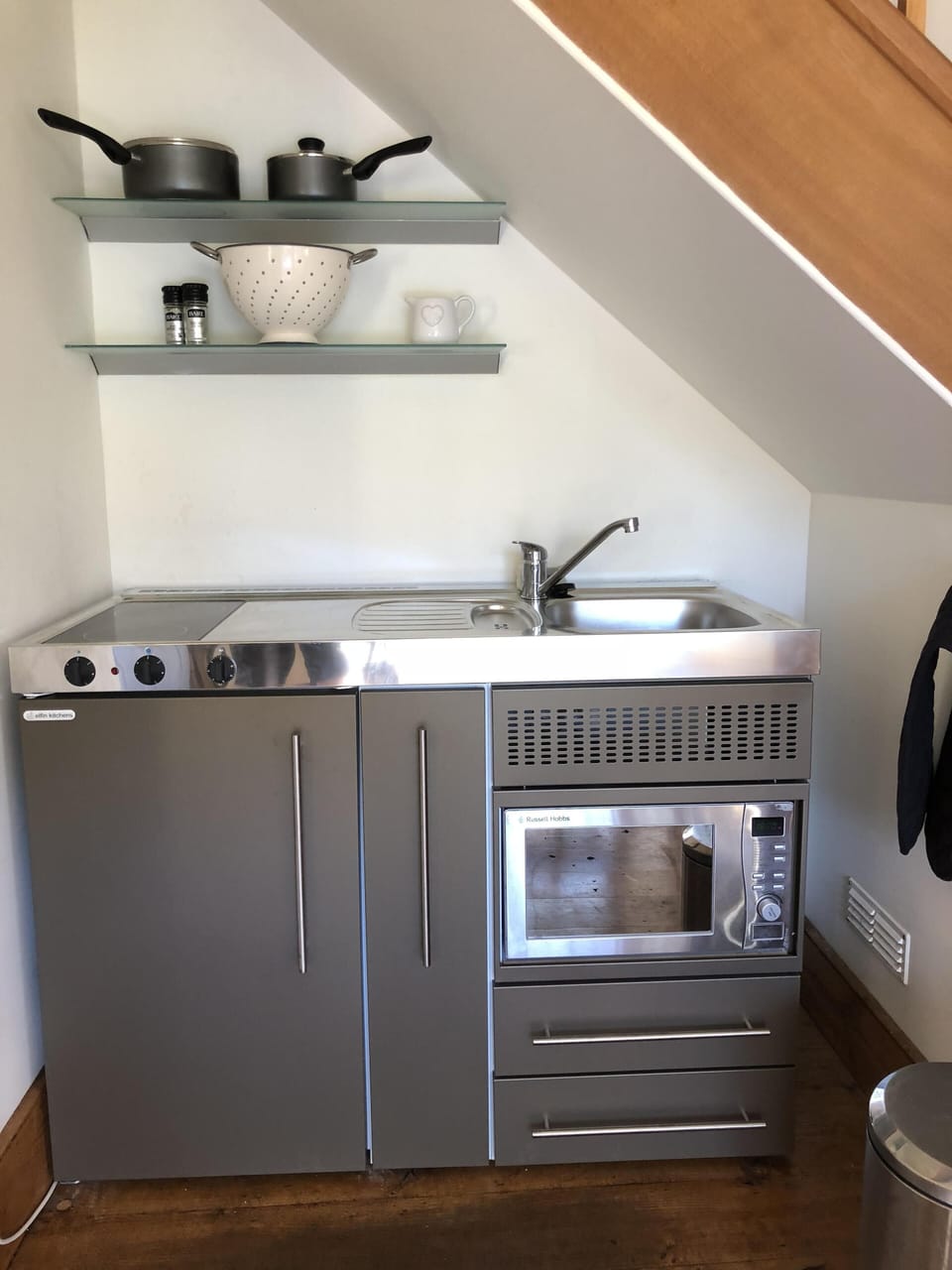 Mini kitchen with induction hobs, combi oven, sink and firdge