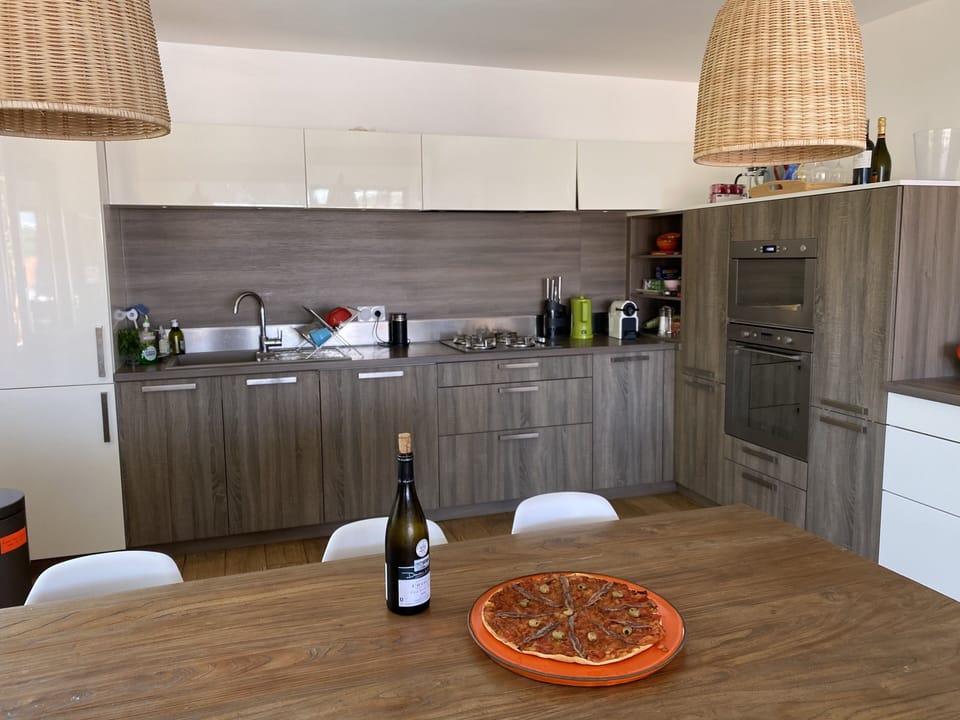 Kitchen, ovens, workspaces, and coffee machines. 