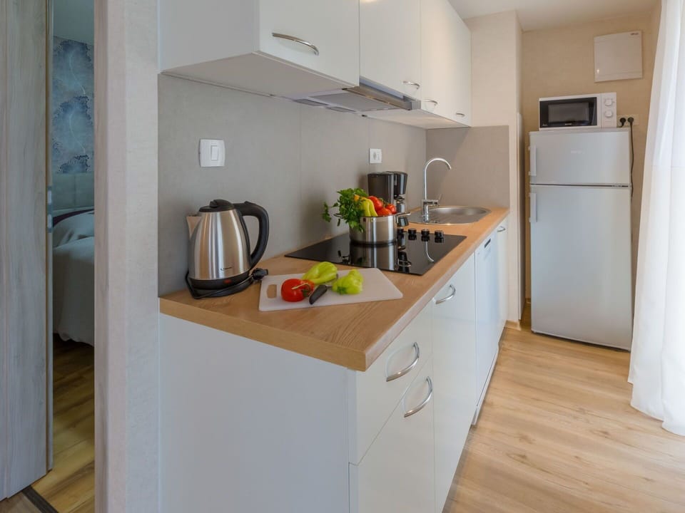Room, Countertop, Property, Kitchen, Furniture, Cabinetry, Refrigerator, Floor, Major Appliance, Interior Design