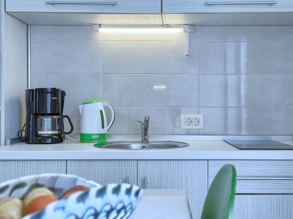 Green, Tile, Room, Countertop, Kitchen, Interior Design, Furniture, Wall, Cabinetry, Small Appliance