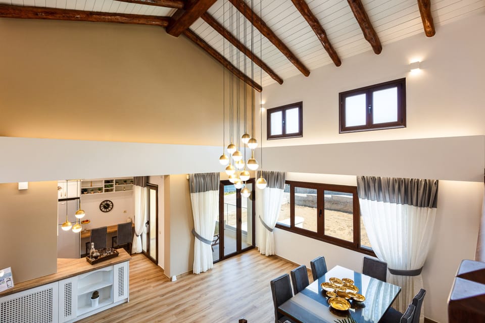 High vaulted ceiling featuring the dining room area and the main kitchen area