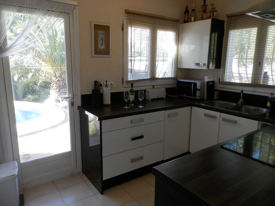 Kitchen has door to pool and terrace