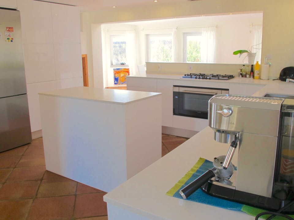 Fully equipped modern kitchen, looking out to garden and pool