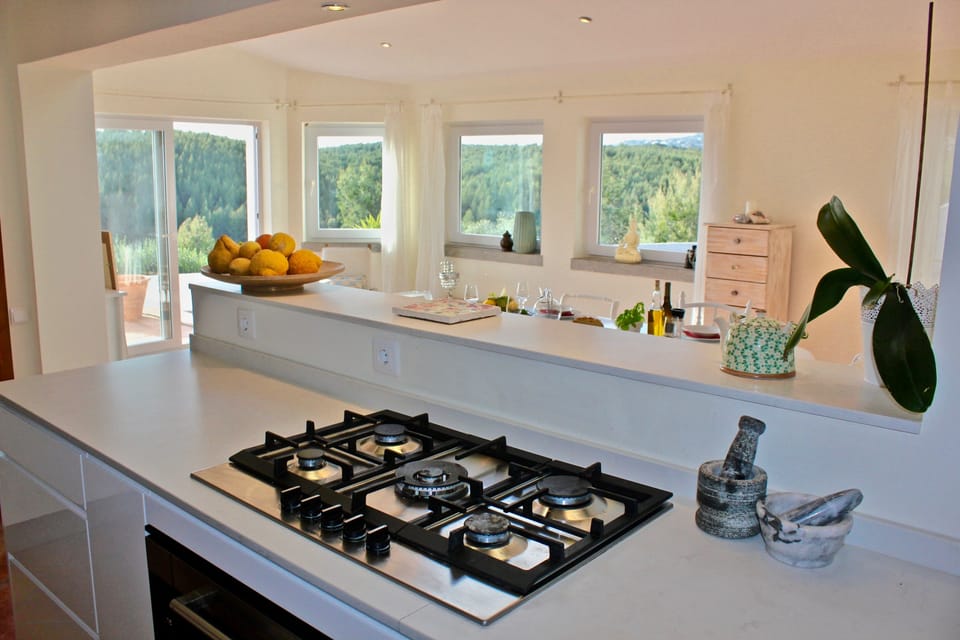 Kitchen/ Dinning room, with window doors to pool and garden