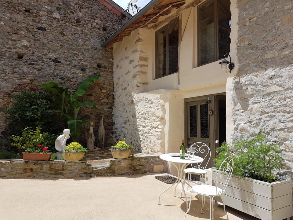 Front door with little coffee table and shady paved terrace