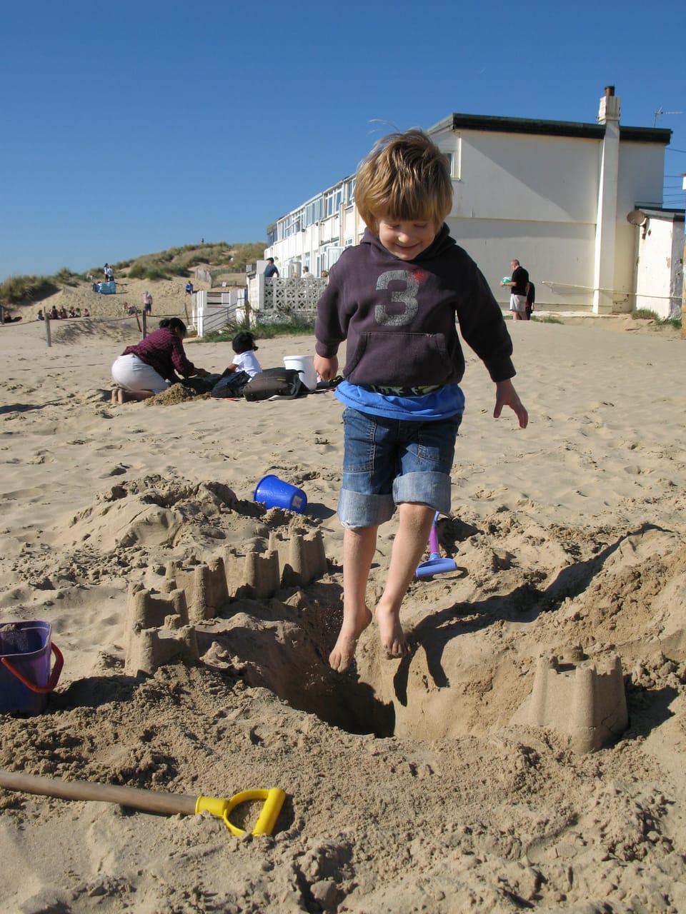 Kids, sandcastles, disappearing into holes...