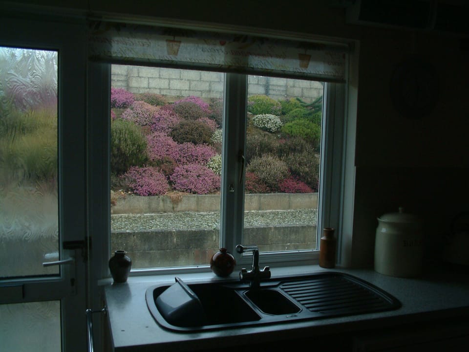 The kitchen looks out onto a beautiful heather garden