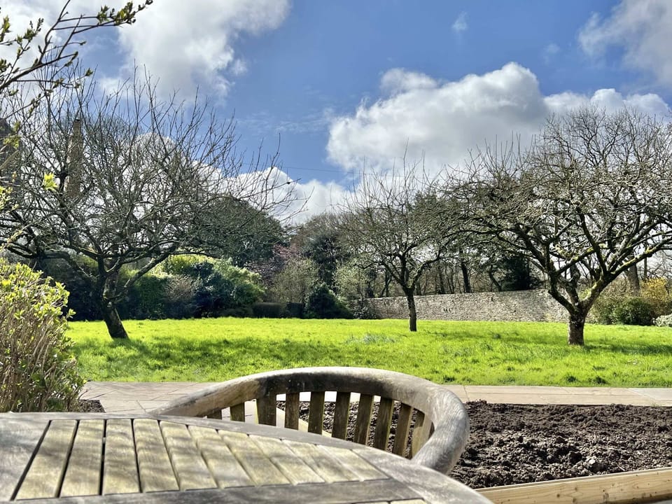 Patio with seating for 4, gas BBQ and view out accross the wall garden