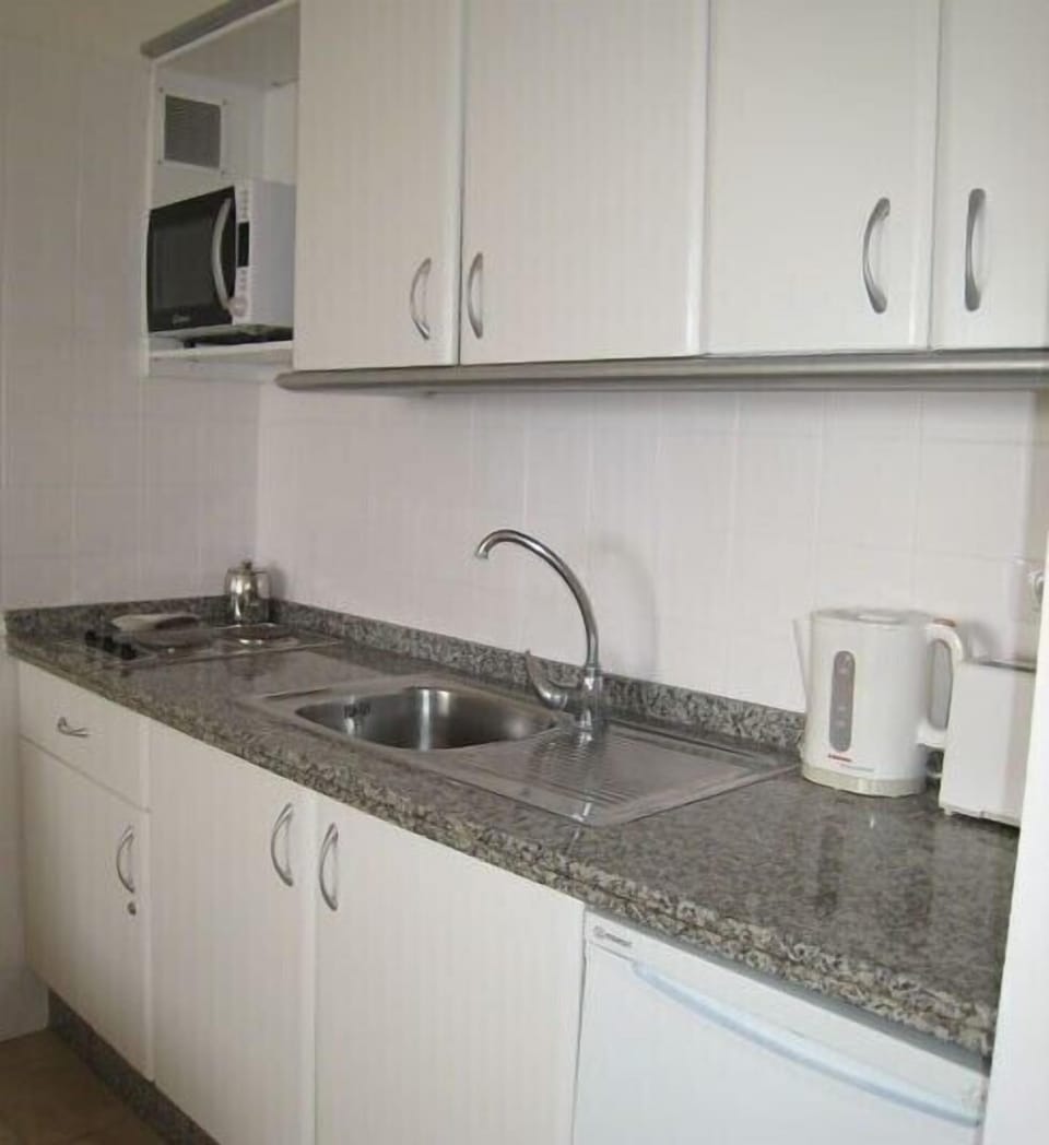Kitchen Area with microwave, oven and grill