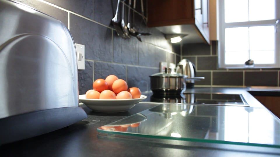 Large worktop space for meal preparation, breakfast bar with 2 stools too.