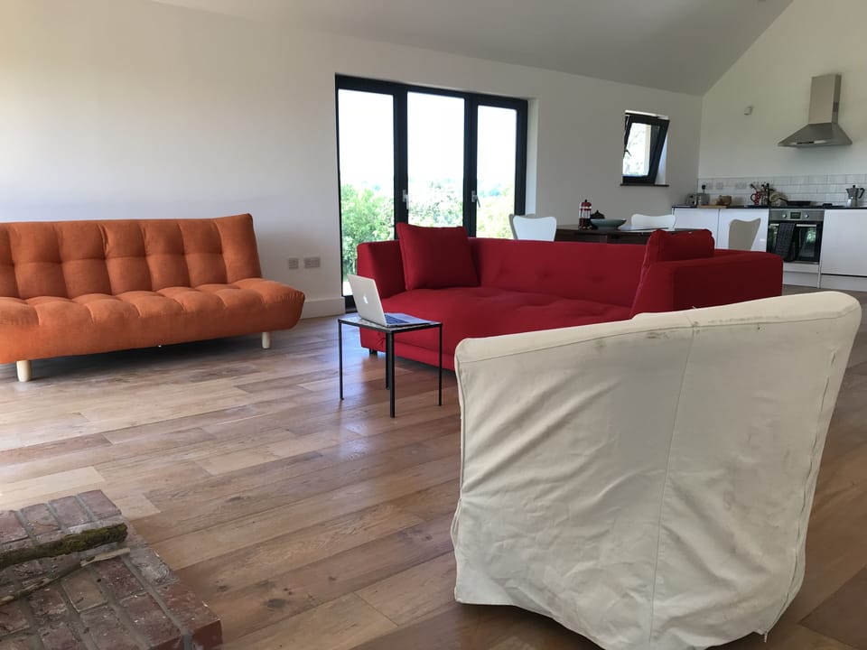 The living room, with the kitchen beyond