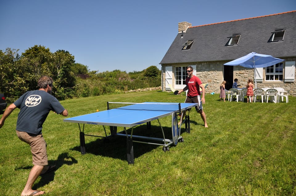 Summer business-as-usual! Adults play ping-pong while kids set the table!