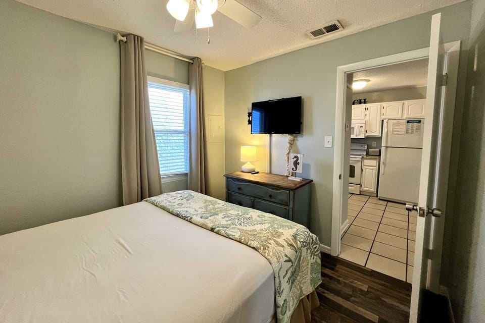 The second bedroom includes a dresser, cable TV, and closet for storage.