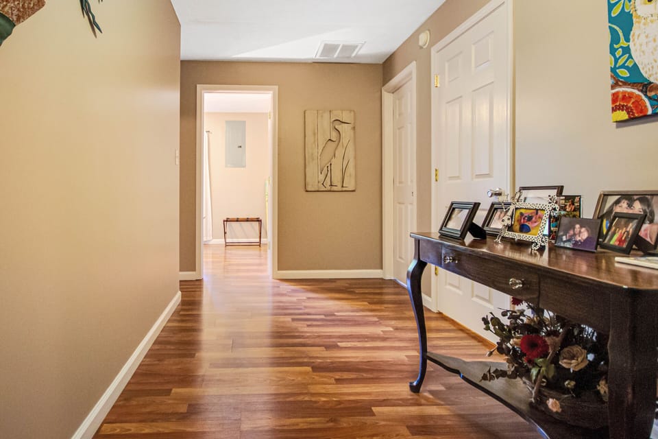 Landing at bottom of stairs. Laundry and utility rooms off of this landing