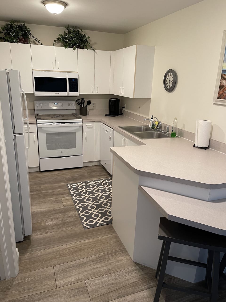 Kitchen with new oven, microwave and dishwasher.  