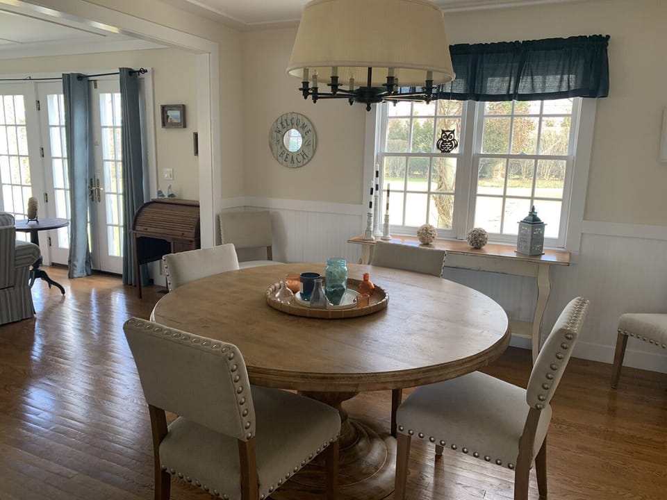Dining Room table comfortably seats six! View of pool and backyard.