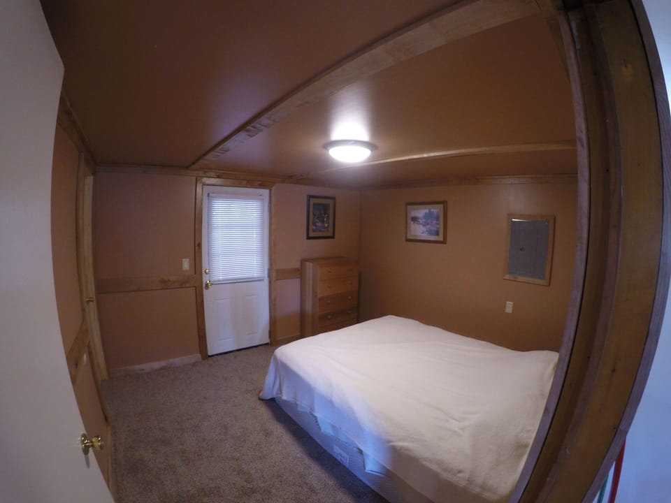 The "Deer Trail" bedroom provides access to the back porch and fire pit area