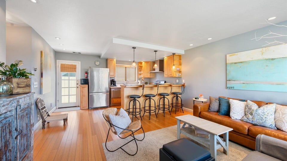The living room opens to the kitchen with counter height dining, wonderful for groups