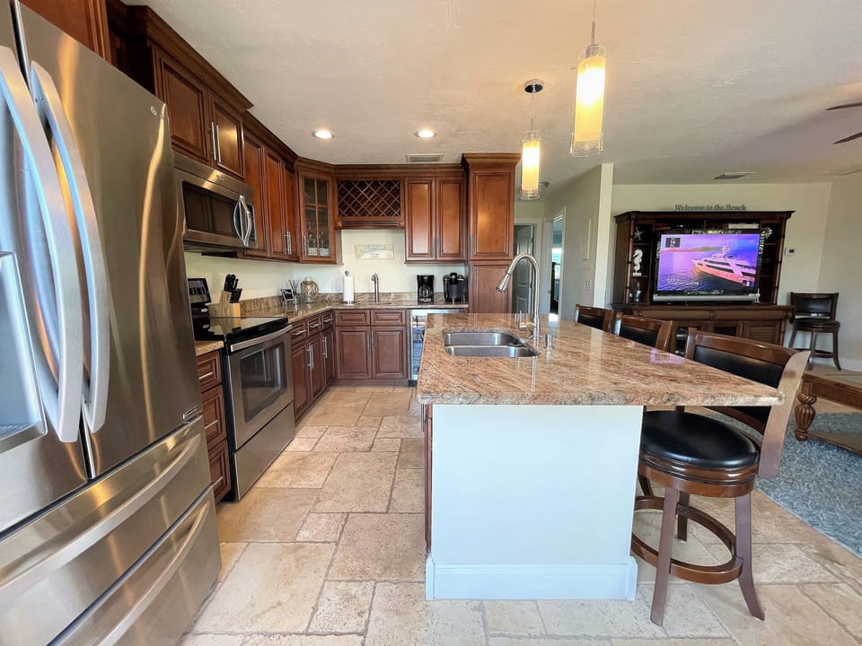 Note the 2-zone wine fridge at the end of the kitchen.  2 separate sinks too.
