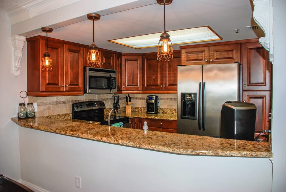 Gorgeously appointed kitchen with wooden cabinets and granite counters