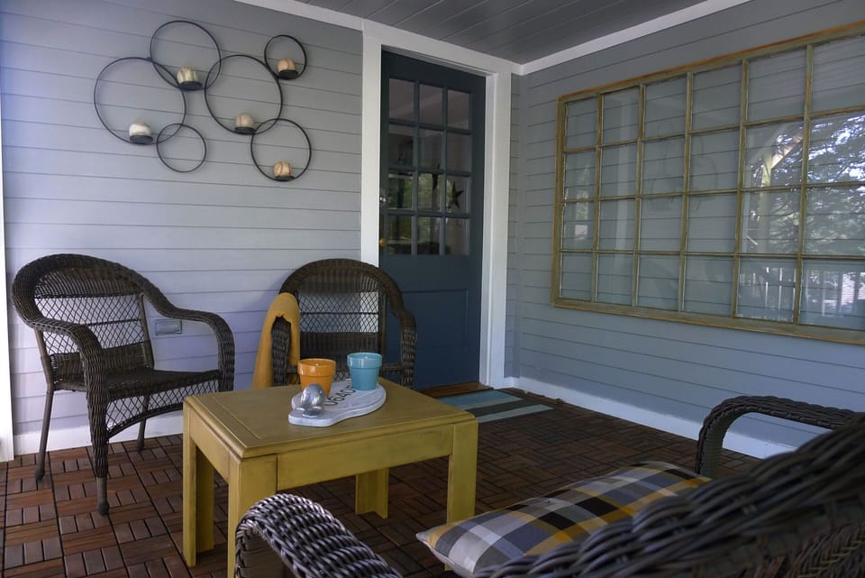 Covered entry porch is accessed from the driveway on Ridge Road.