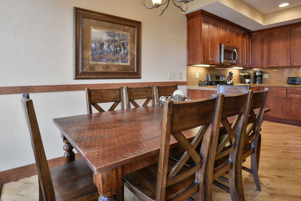 Dining area with seating for eight and three more at the nearby kitchen island.