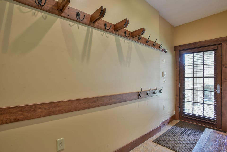 Plenty of convenient ski, snowboard and clothing storage on custom ski racks.