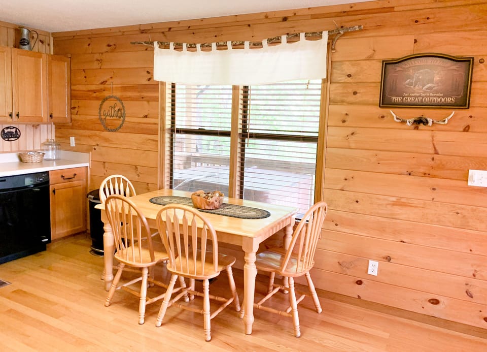 Kitchen table seats 6 comfortably, with 4 chairs and a bench.  