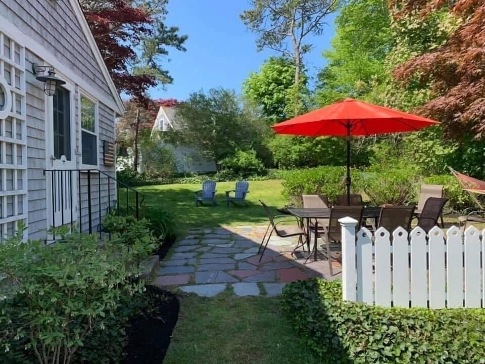 Patio with dining table, fire pit and hammock