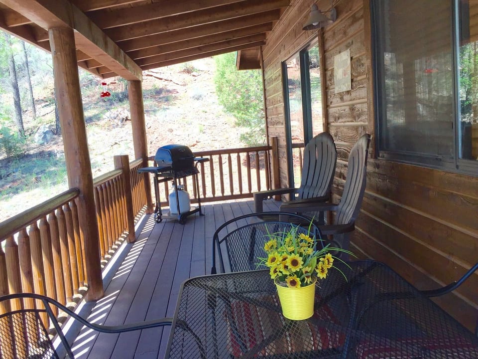 Extended Balcony with gas BBQ, comfortable Adirondack chairs & patio table set.