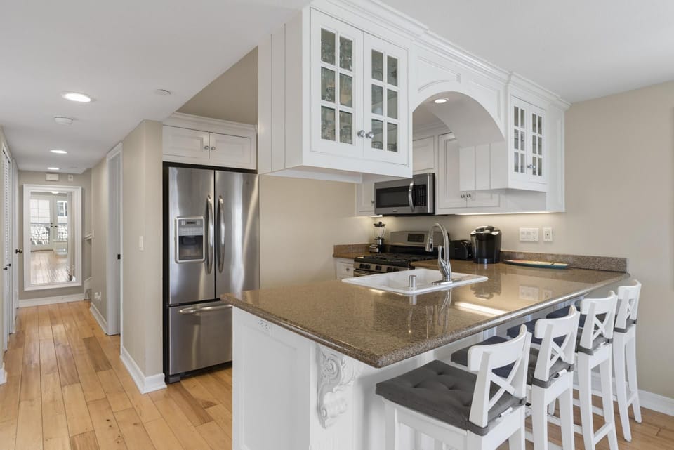Beyond the kitchen is the hallway, leading to the third floor.
                